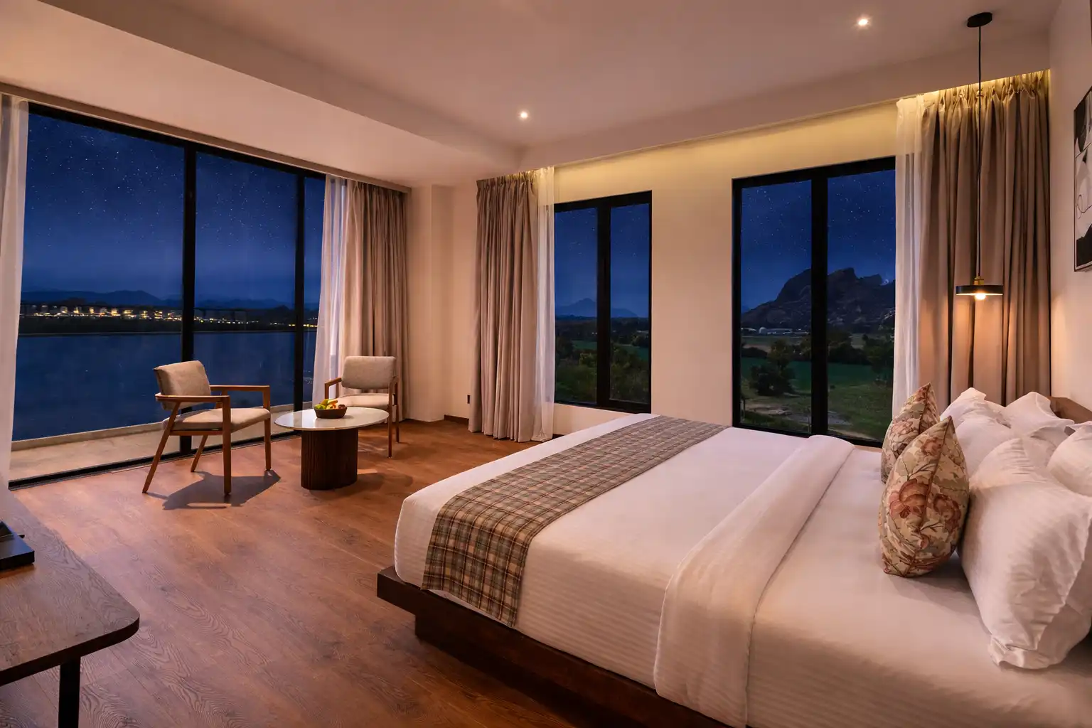 Spacious Premium Room with Balcony layout at Avisa Hotel & Resort showing wide open glass panels looking over the Aravali hills.